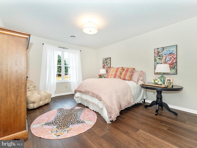 bedroom with dark hardwood / wood-style flooring