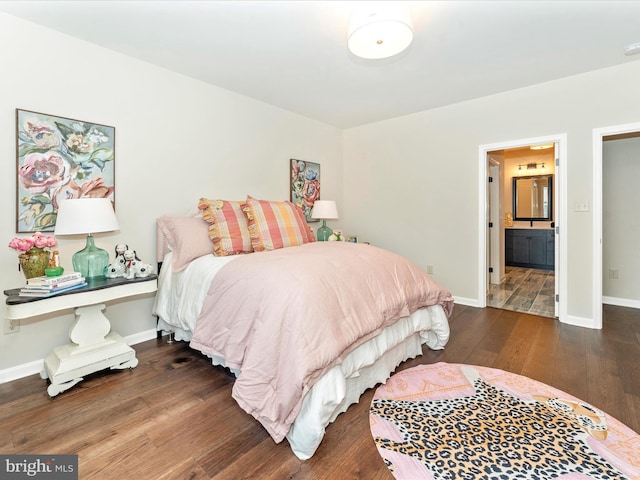 bedroom with dark hardwood / wood-style floors and connected bathroom