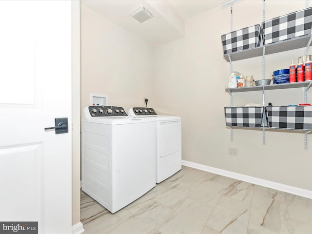 laundry room featuring separate washer and dryer