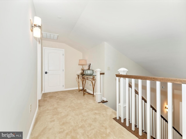 hall featuring carpet floors and vaulted ceiling