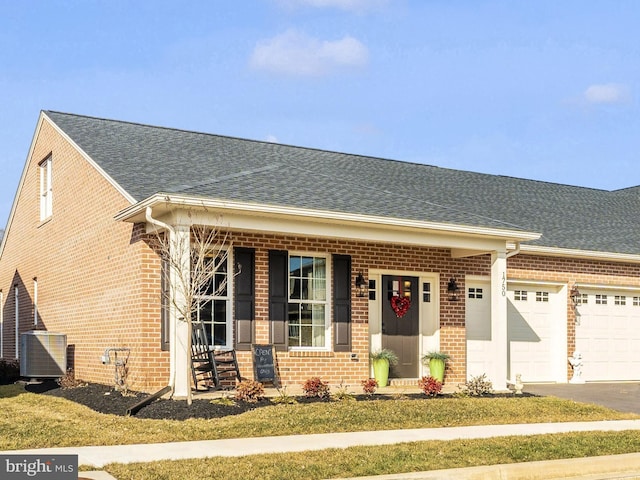 view of front of house featuring a garage and central AC unit