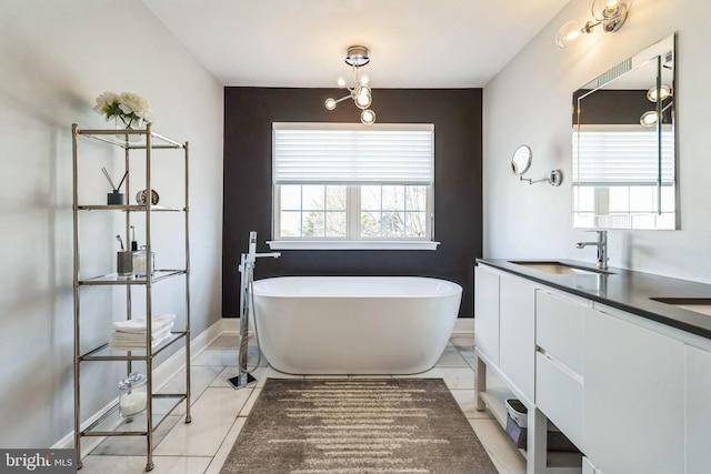 bathroom featuring tile patterned floors, vanity, and a bathtub