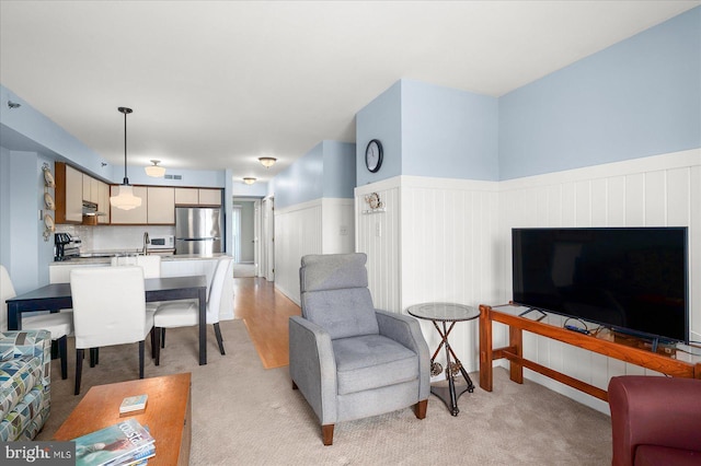 living room with a wainscoted wall and visible vents