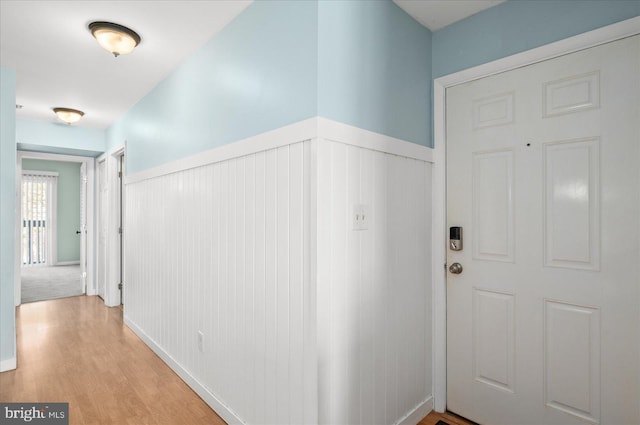 foyer featuring a wainscoted wall and light wood-style flooring