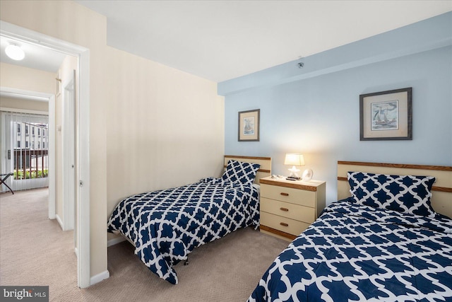 bedroom with baseboards and light colored carpet