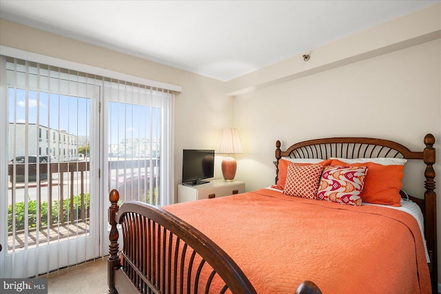 carpeted bedroom featuring access to outside