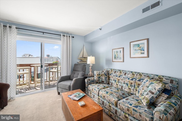 carpeted living room featuring visible vents