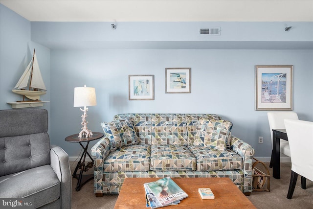 carpeted living area featuring visible vents and baseboards