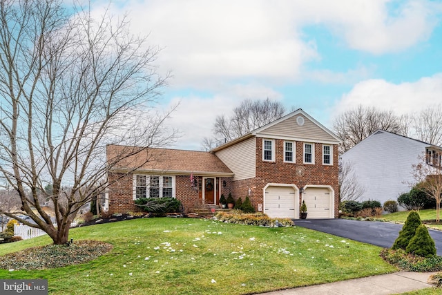 split level home with a garage, brick siding, a front lawn, and aphalt driveway