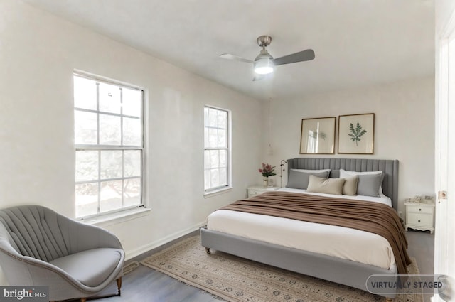 bedroom with wood-type flooring and ceiling fan