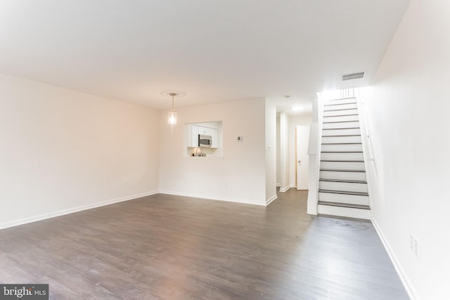 unfurnished living room featuring dark hardwood / wood-style flooring