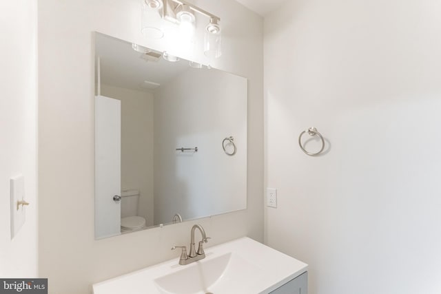 bathroom with vanity and toilet