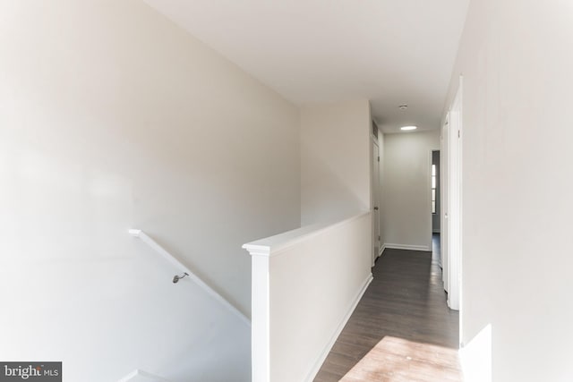 corridor with dark hardwood / wood-style flooring