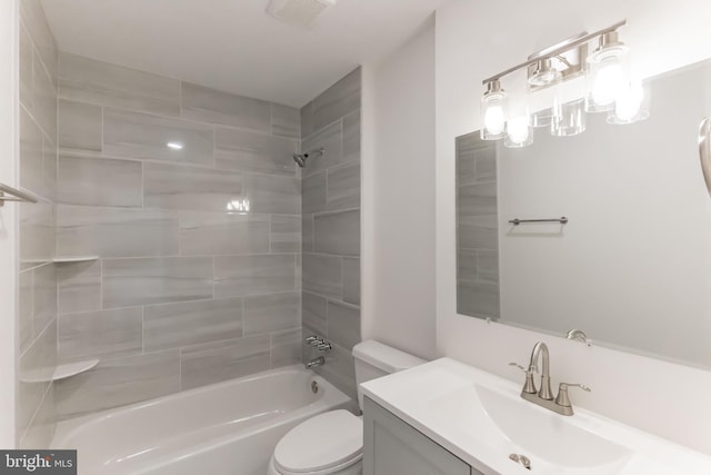 full bathroom featuring tiled shower / bath combo, vanity, and toilet