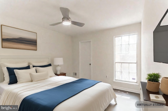 bedroom with ceiling fan and hardwood / wood-style floors