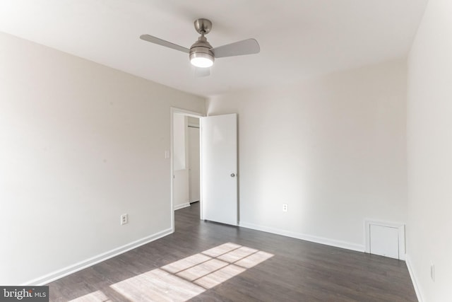 unfurnished room featuring ceiling fan and dark hardwood / wood-style flooring