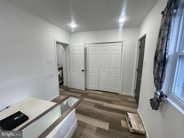 foyer entrance with wood finished floors and baseboards