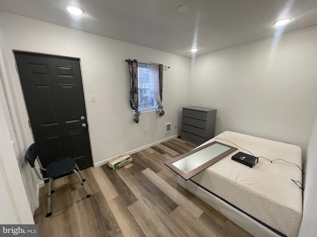 interior space featuring recessed lighting, visible vents, baseboards, and wood finished floors