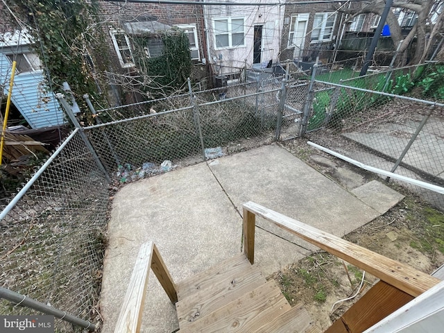 view of patio featuring a gate and fence