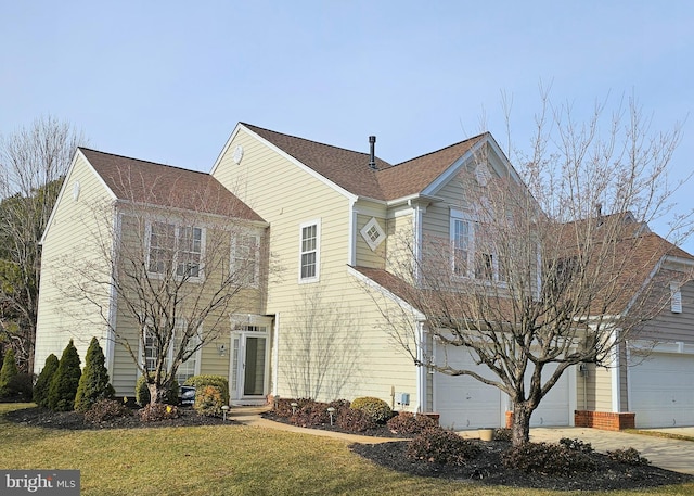 view of property with a garage and a front yard