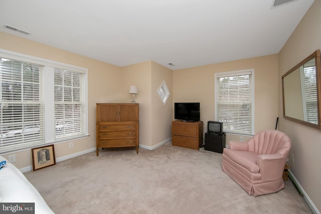 sitting room featuring light colored carpet