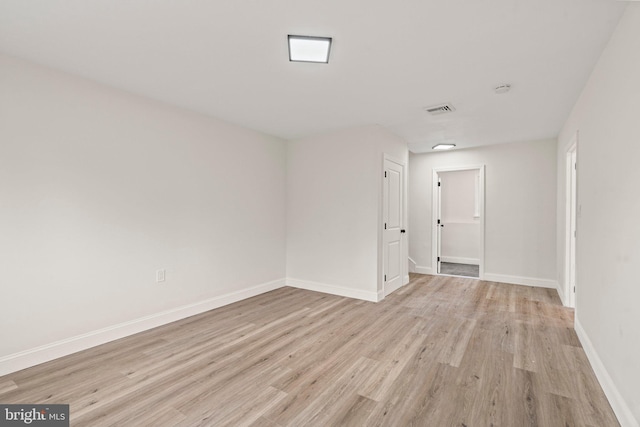 unfurnished room with light wood-type flooring