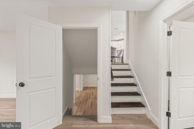 stairs featuring wood-type flooring