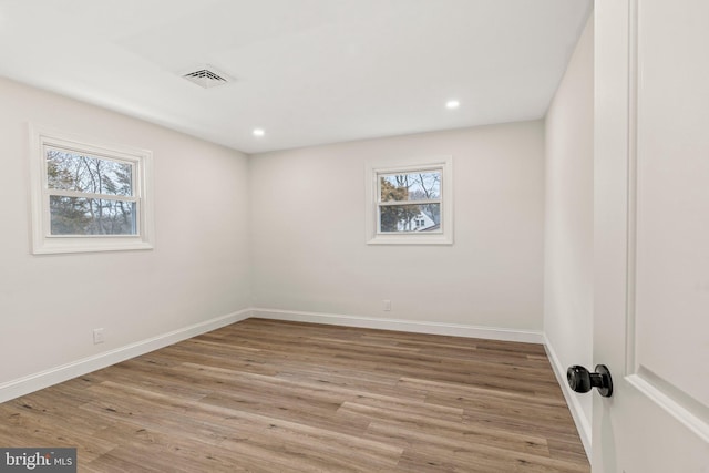 spare room featuring light wood-type flooring