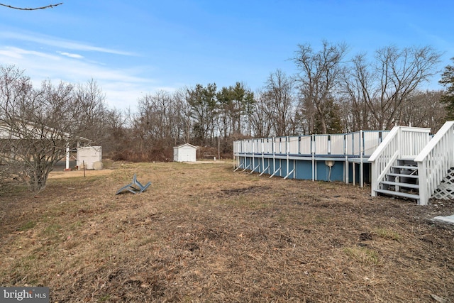 view of yard with a pool side deck and a shed