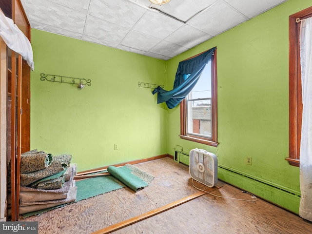 interior space with a baseboard radiator and baseboards