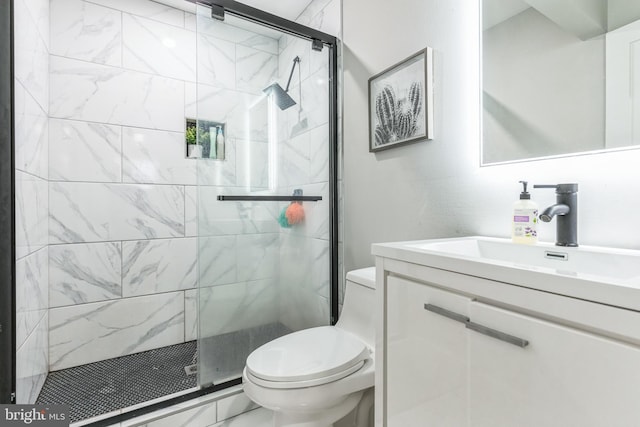 bathroom with vanity, an enclosed shower, and toilet