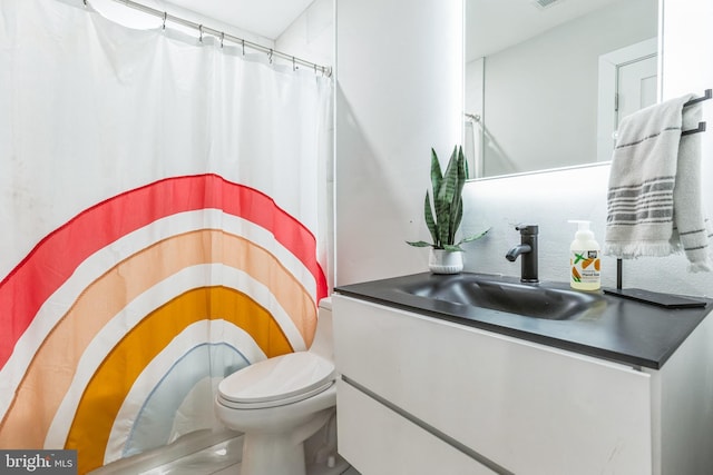 bathroom featuring vanity, toilet, and curtained shower