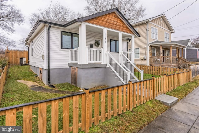 bungalow featuring covered porch and central air condition unit