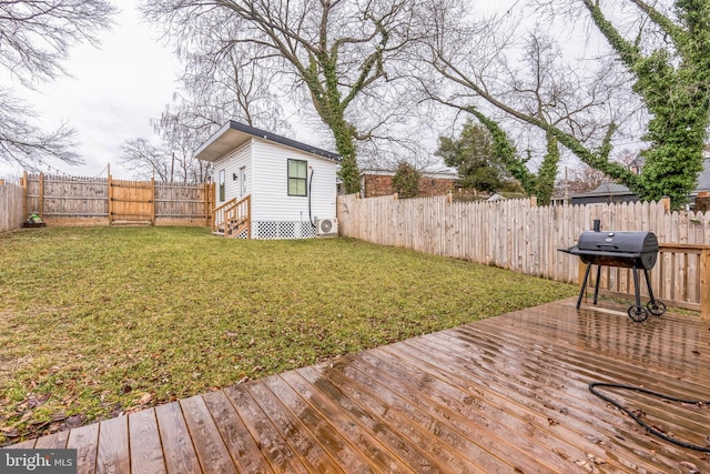 wooden deck with area for grilling and a yard