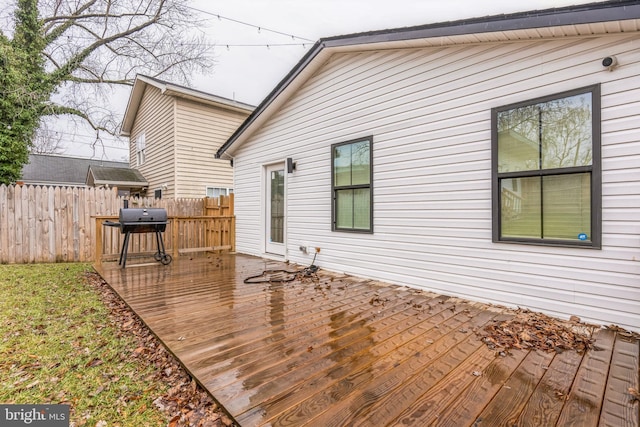 wooden deck with a grill