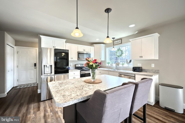 kitchen featuring a center island, white cabinets, and appliances with stainless steel finishes