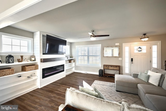 living room with wood-type flooring, a wealth of natural light, and ceiling fan