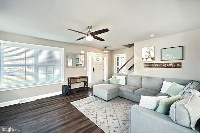 living room featuring hardwood / wood-style floors and ceiling fan