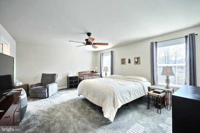 carpeted bedroom with multiple windows and ceiling fan