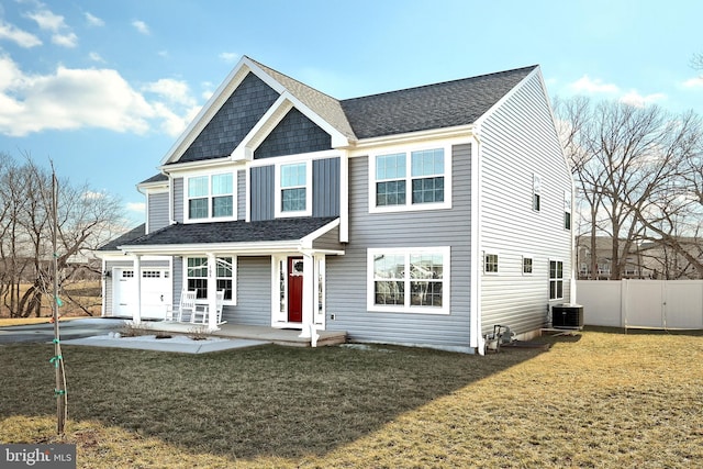 view of front of home featuring central AC and a front lawn