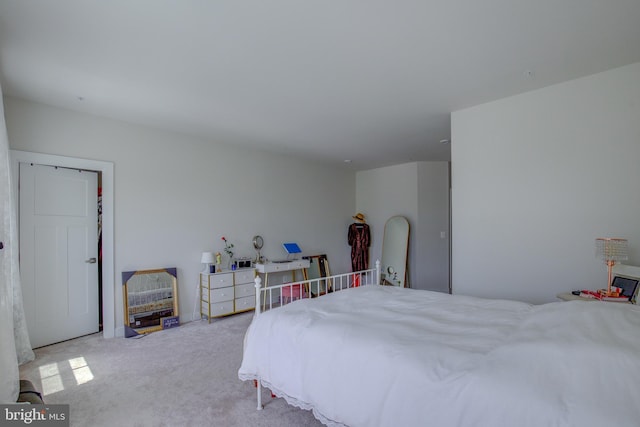 bedroom featuring light carpet