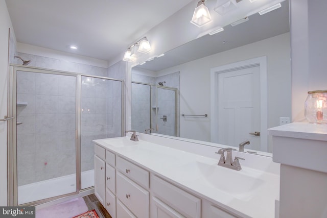 bathroom with walk in shower and vanity