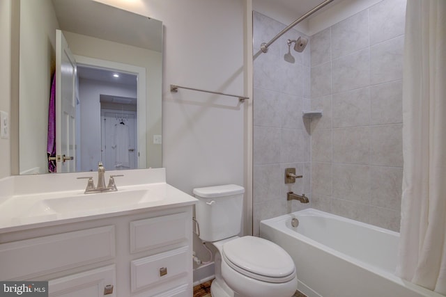 full bathroom with vanity, shower / bath combo with shower curtain, and toilet