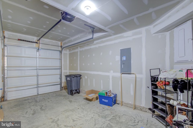 garage with a garage door opener and electric panel