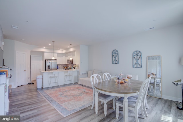 dining space featuring light wood-type flooring