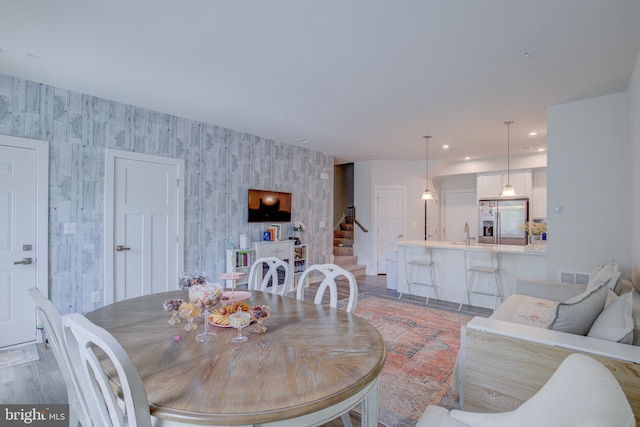 dining room with hardwood / wood-style flooring and sink