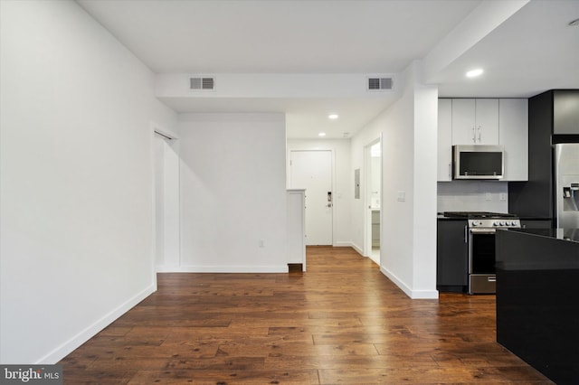 1501 N 31st St Unit 205, Philadelphia, PA 19121 - kitchen with visible vents, white cabinets, dark countertops, appliances with stainless steel finishes, and dark wood-style flooring