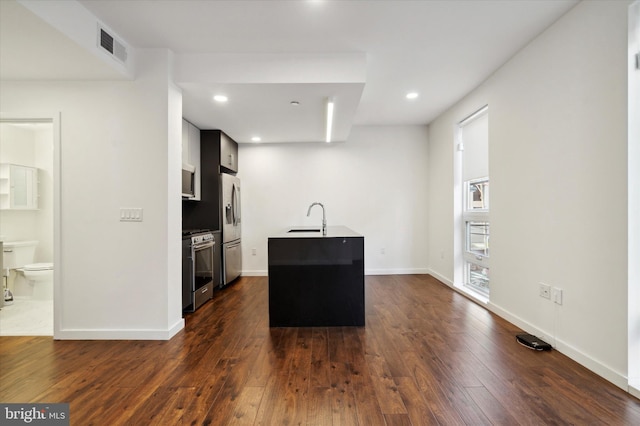1501 N 31st St Unit 205, Philadelphia, PA 19121 - kitchen featuring dark wood finished floors, visible vents, appliances with stainless steel finishes, a sink, and an island with sink