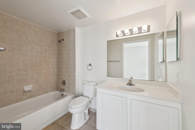 full bathroom featuring vanity, tile patterned flooring, tiled shower / bath, and toilet