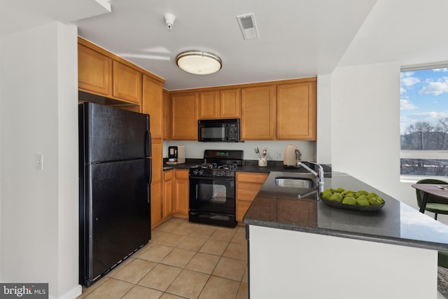 kitchen featuring light tile patterned flooring, sink, kitchen peninsula, and black appliances